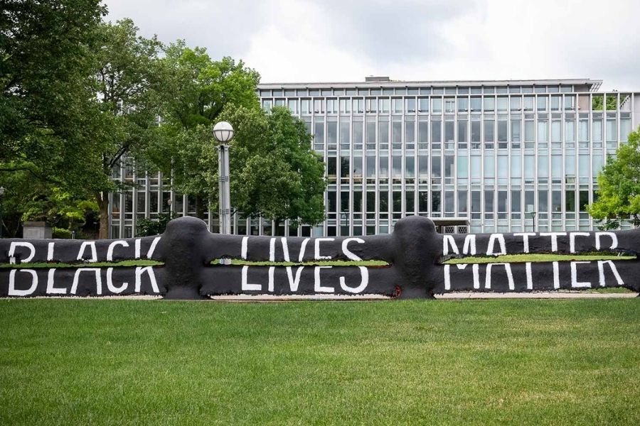 Fence on Carnegie Mellon's campus painted black with the words "Black Lives Matter"