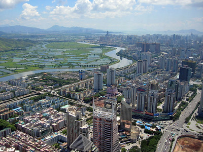 photo of a cityscape in the foreground and a winding river in the background