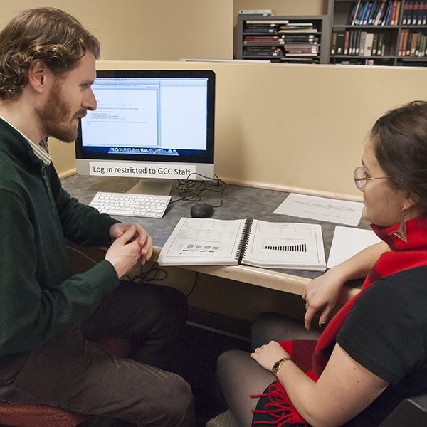 two students reviewing a presentation