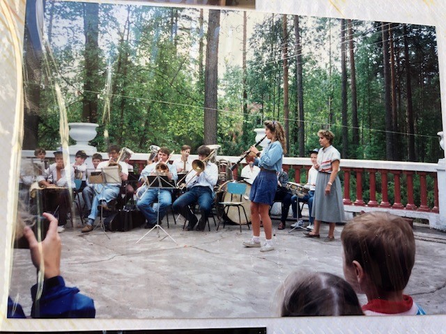 Christine Menand plays the clarinet for an audience at a rural Russian summer camp.