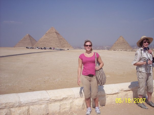 Kensee poses in front of the great pyramids of Giza.
