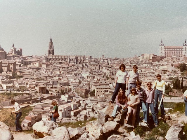 Linda Gentile and her high school classmates pose on a bluff overlooking a city in Spain.