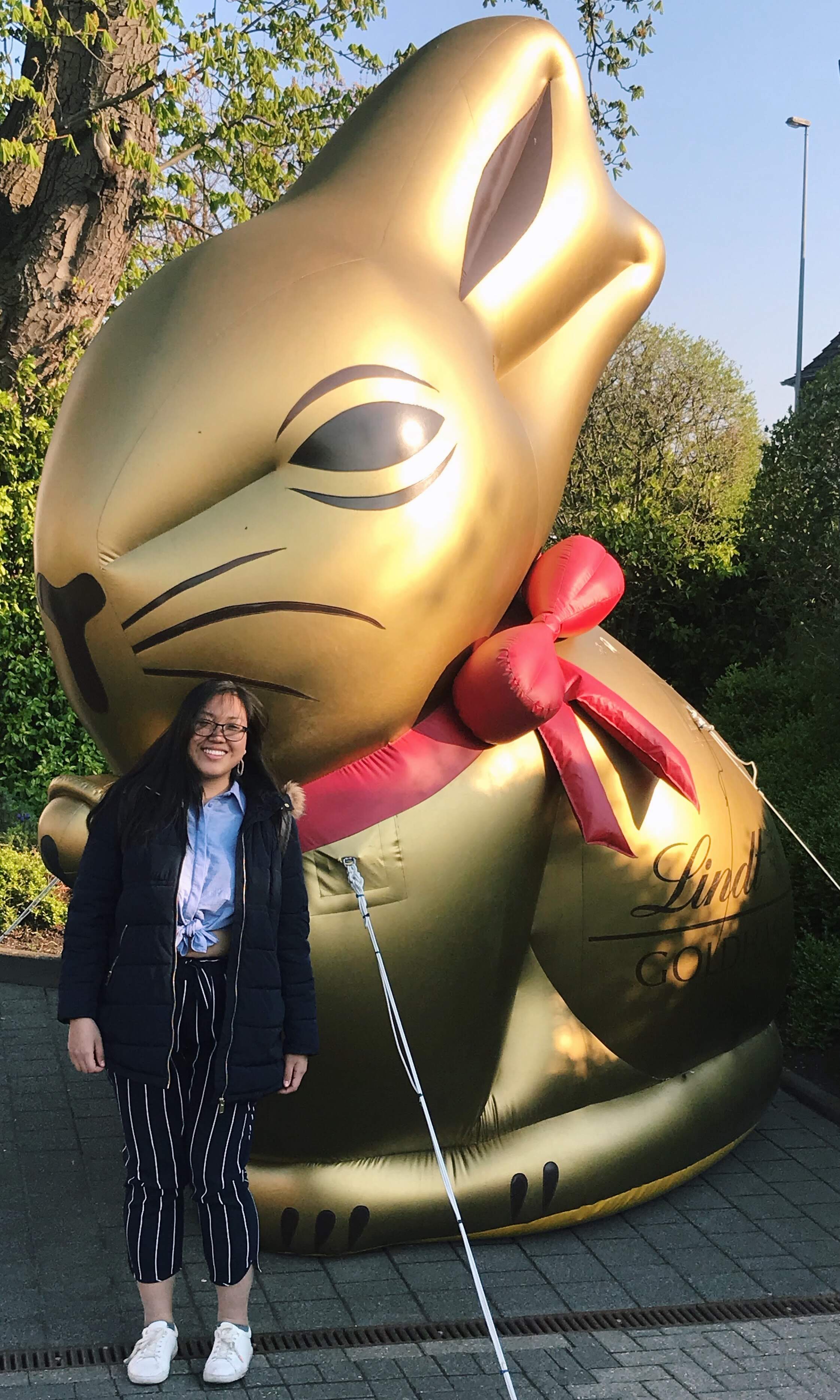 Lisa Han posing in front of a large, inflatable bunny rabbit
