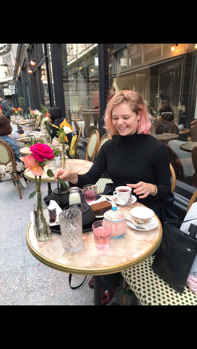 Cate Hayman drinking tea at a cafe