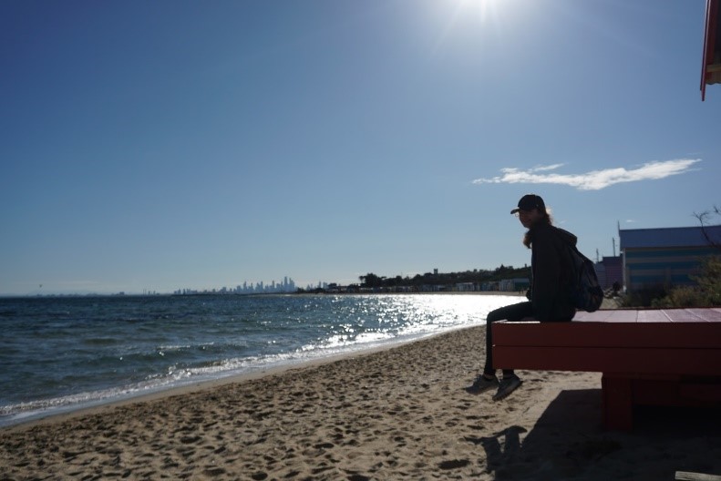 Solana Morningstar sits on a beachfront dock.