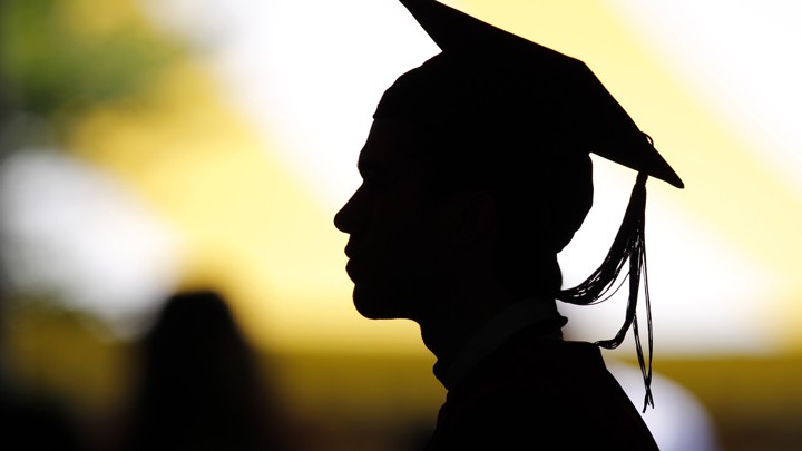 Silhouette of student in cap and gown 