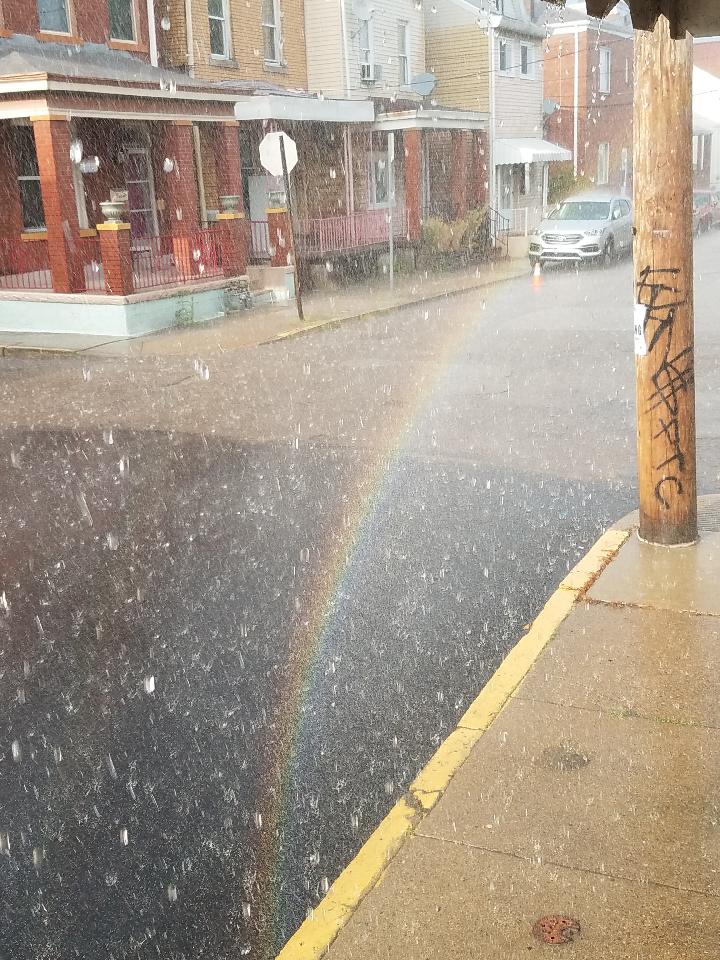Rainbow on a city street corner.