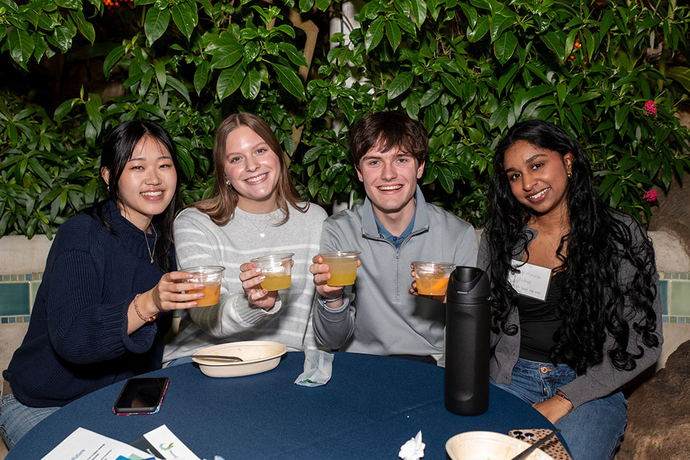 YCAC High School Leader Emma Ehan, Addie Baker, Derek Ulewicz, and YCAC Team Lead Anwita Maneish Nithya enjoy a mocktail in Phipps Conservatory's Tropical Forest Panama. 