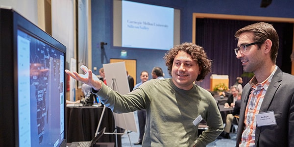 photo of student speaking to an investor