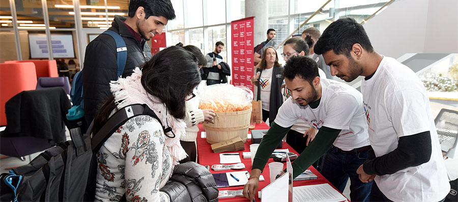 Students man a table on Giving Tuesday