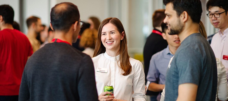 Three alumni chatting at a reunion social event