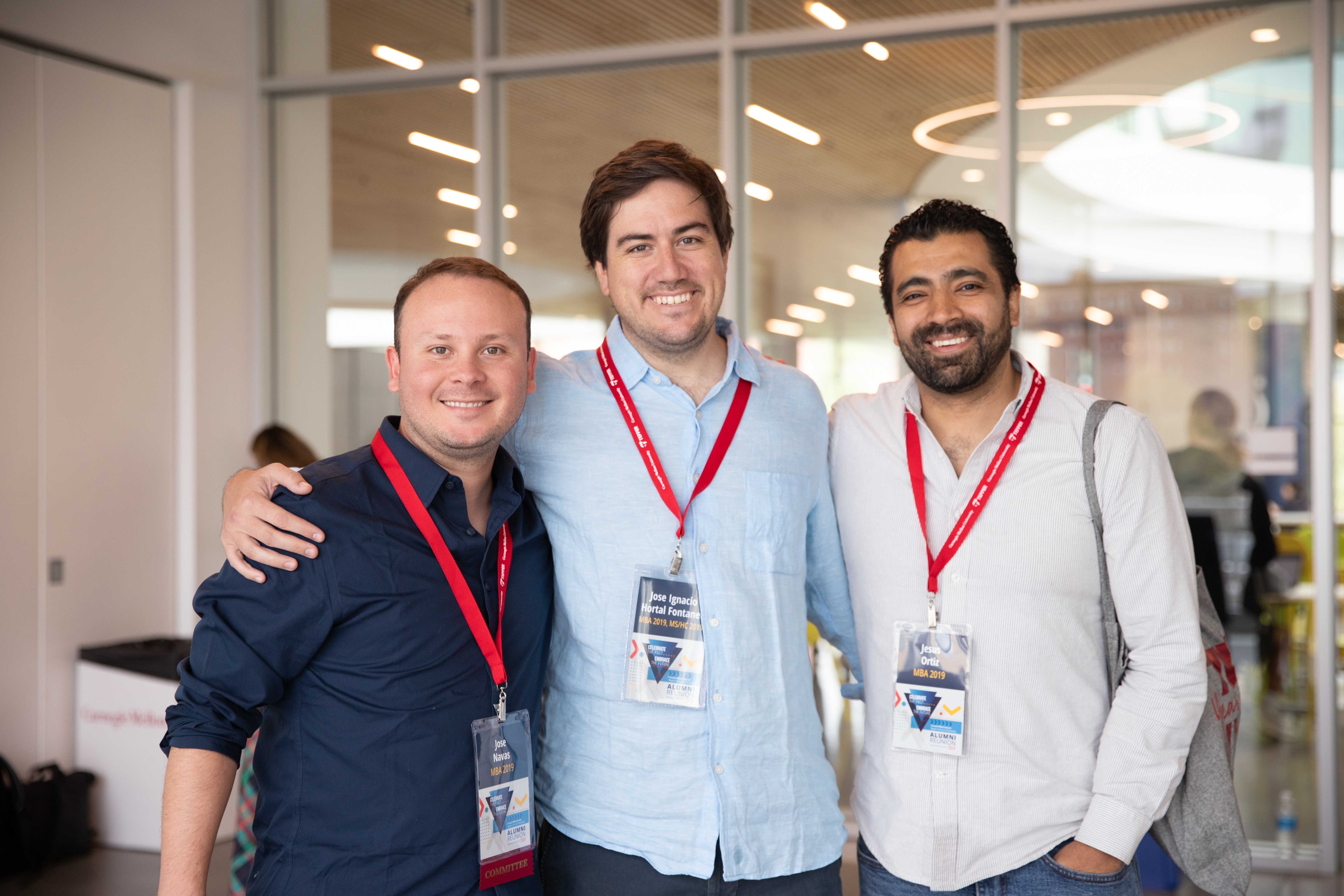 Three alumni gather at a reunion event