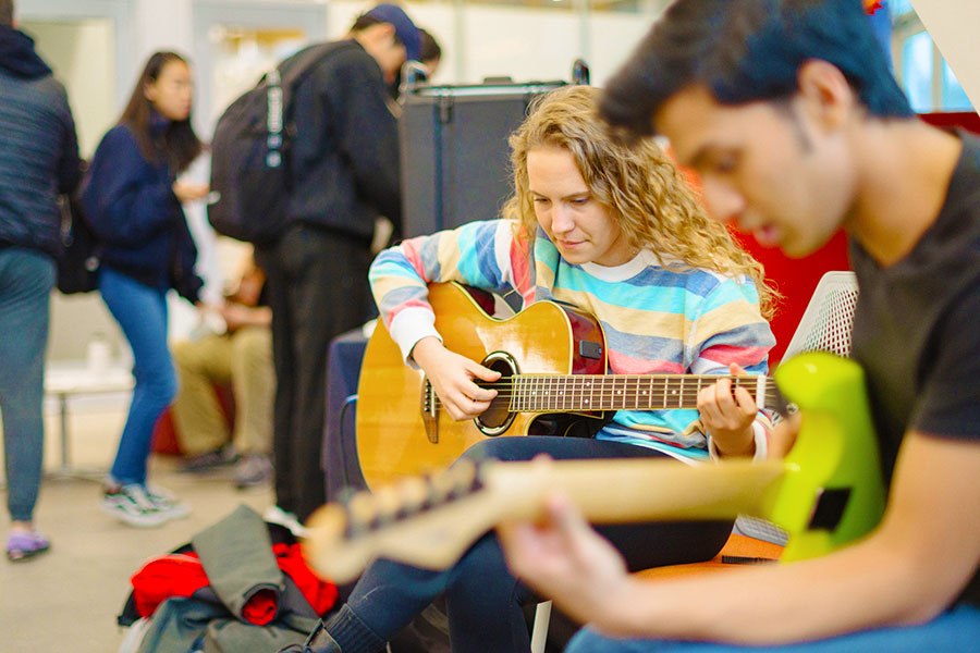 Students playing guitars