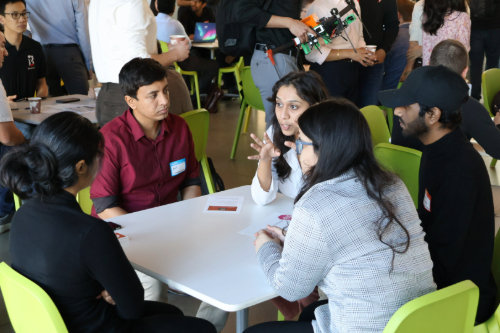 Four people sitting at a table talking