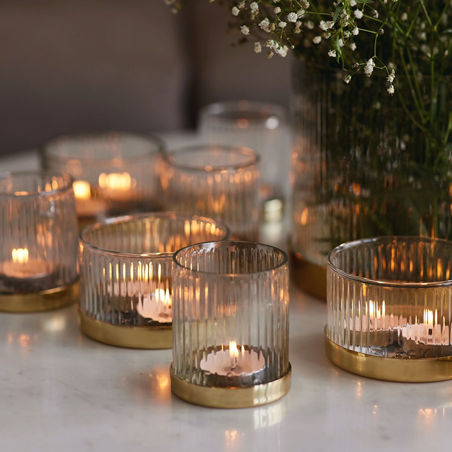 Anacua House sparkling smoky quartz colored votive candles sparkling in candlelight.