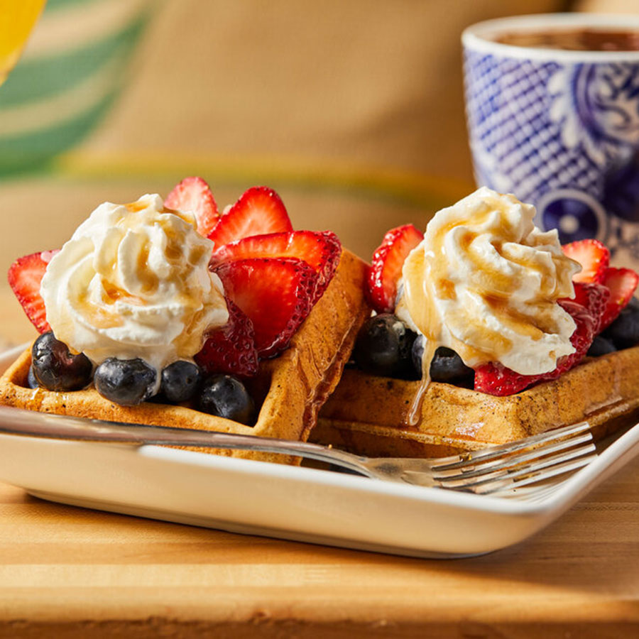 Waffles with whipped cream and strawberries