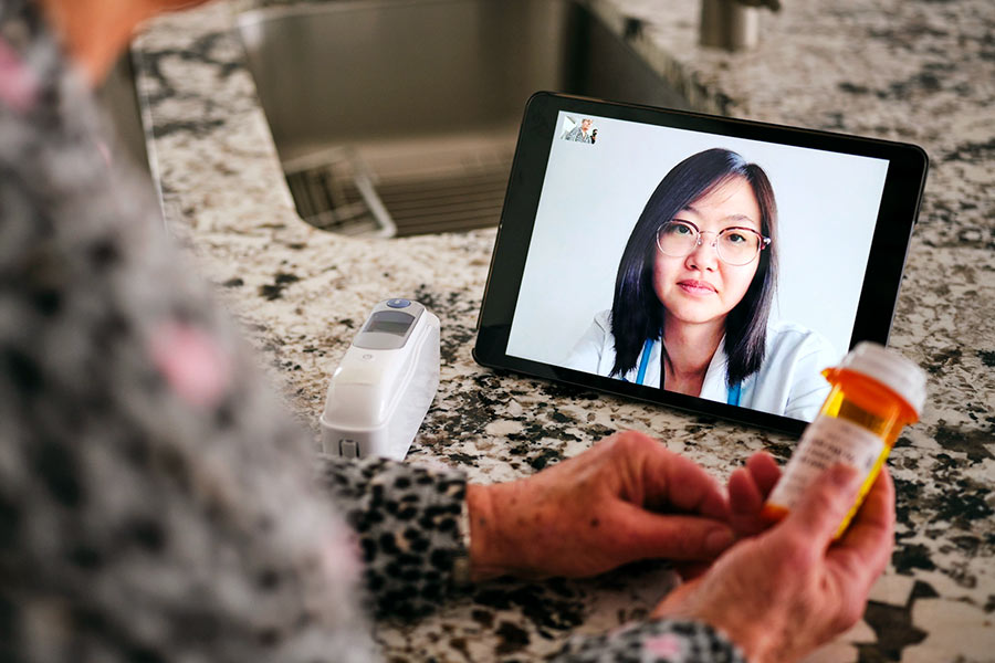 Patient at home video conferencing with doctor
