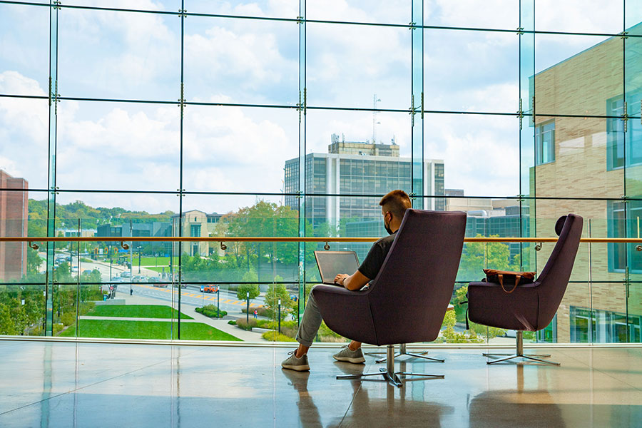 student working inside tepper quad overlooking atrium