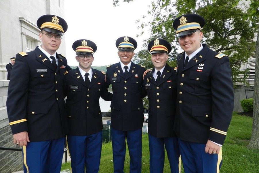 MBA student Josh in full military uniform with group of colleagues.