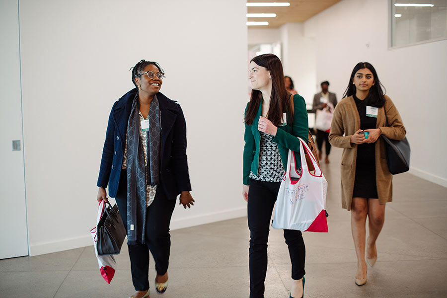 Conference attendees walking through a hall