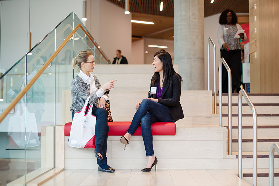 Two female conference attendees talking