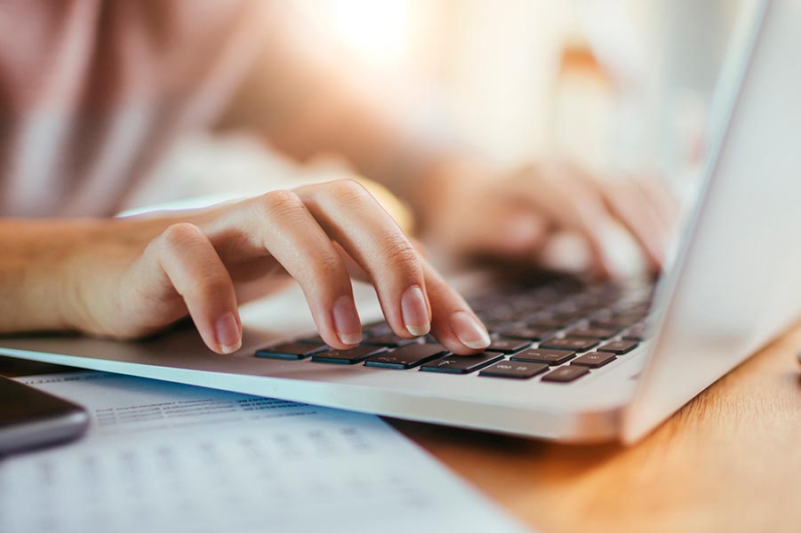 Female hands on laptop keyboard