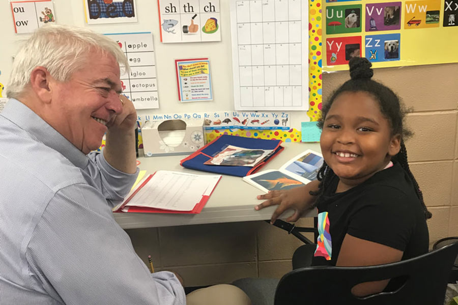 A volunteer reading with a child