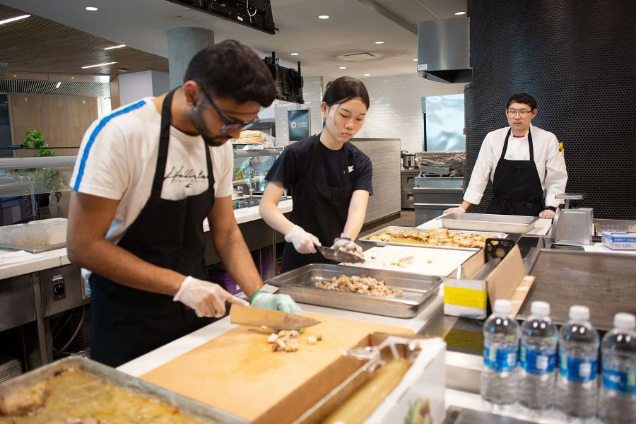 capital grains student workers preparing food