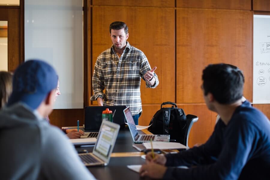 photo of graduate student speaking in front of class
