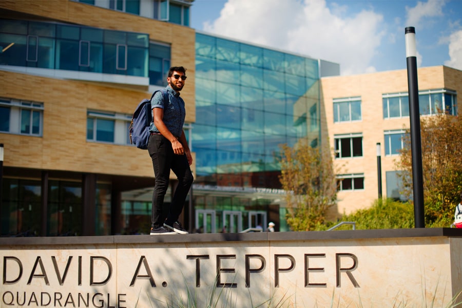 Male student in front of Tepper Quad