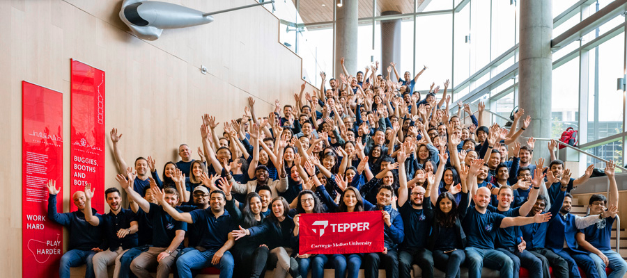 MBA class on steps with banner