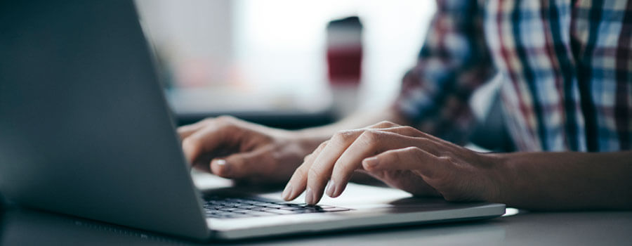 hands on a laptop keyboard