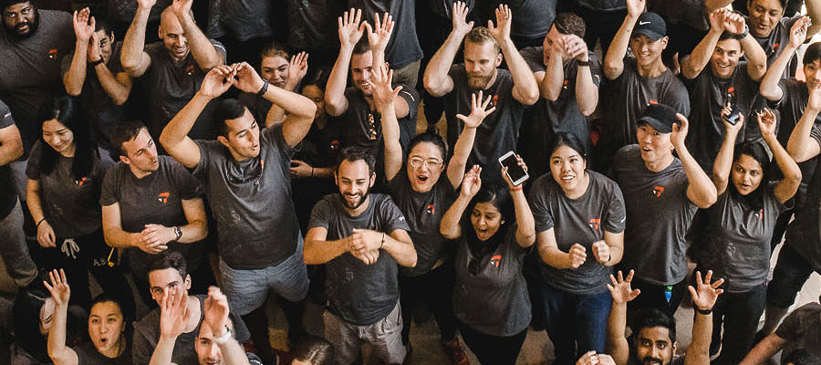 Large group photo with hands in the air