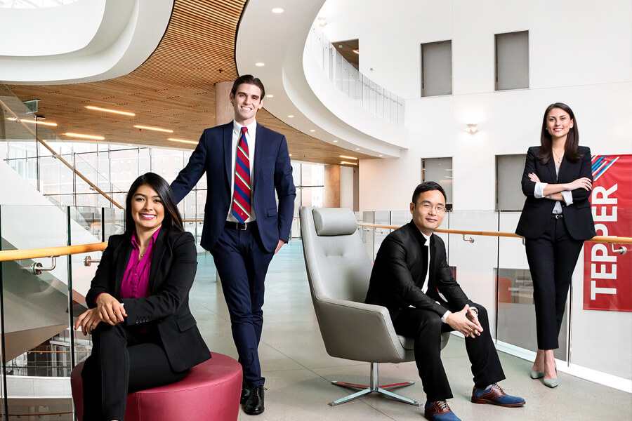 Tepper MBAs, two men and two women, in the Tepper Quad