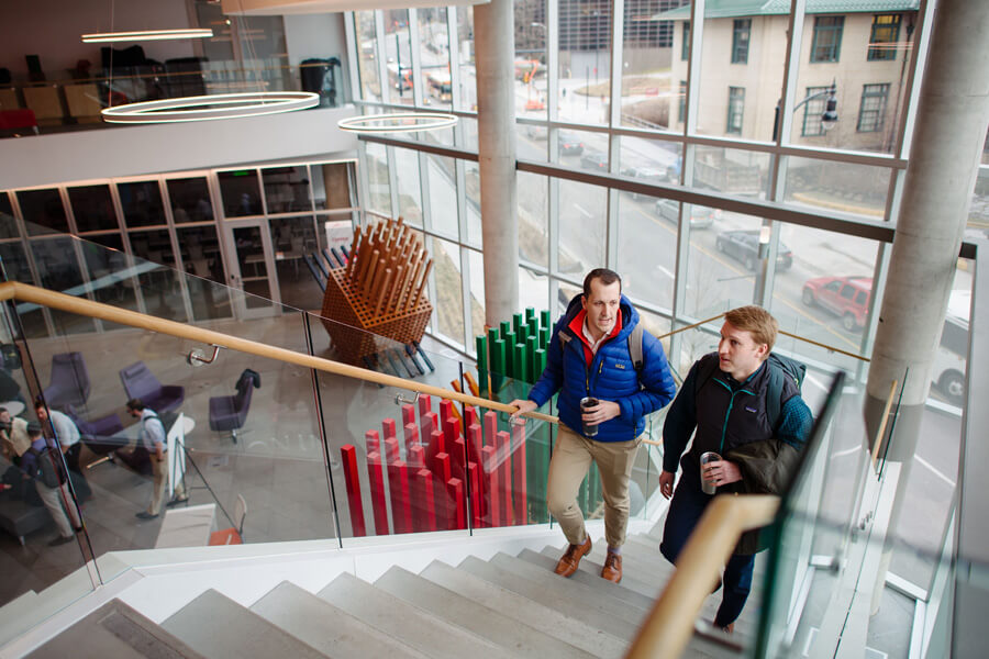 Two students walking up the stairs in the Tepper Quad