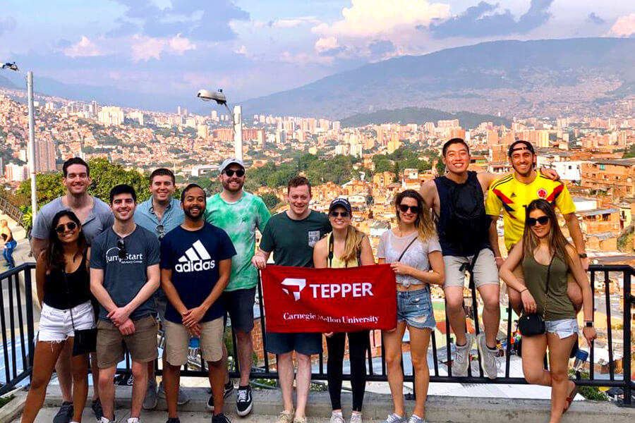 A group of Tepper students in Colombia, holding Tepper flag.