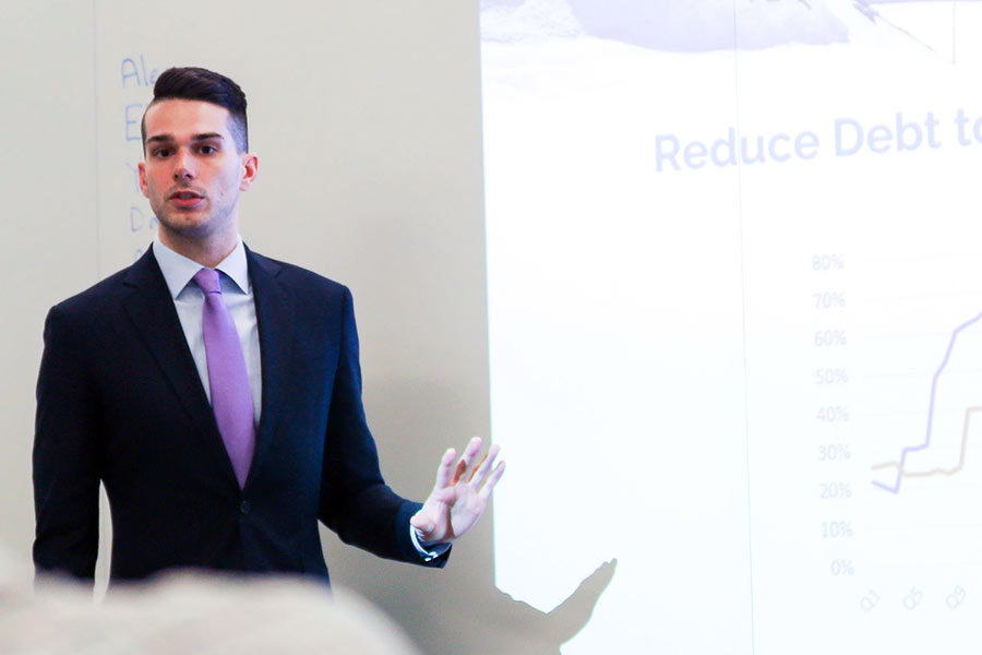 Male student presenting during management game