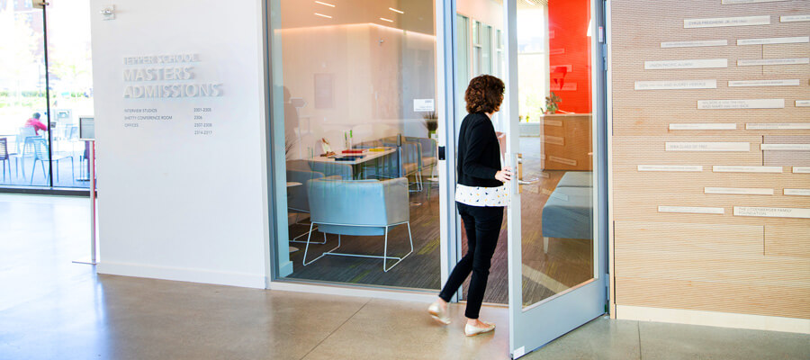Female walking into the Tepper MBA Admissions office