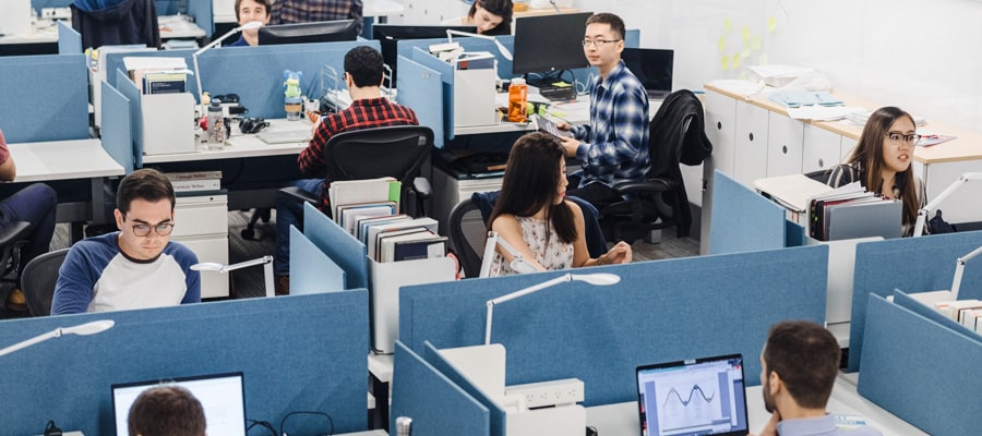 group of students at divided blue study desks