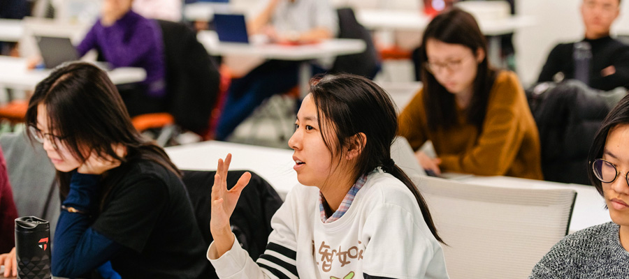 Female student engaging in discussion in class