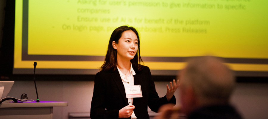 Female student presenting in front of a class