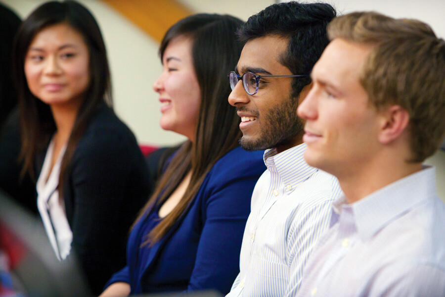 close up photo of undergraduate students in audience at recruiting event