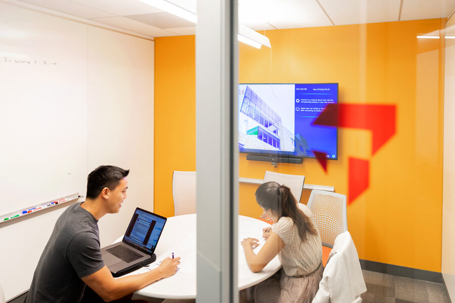 Photo of two students studying in a breakout room.