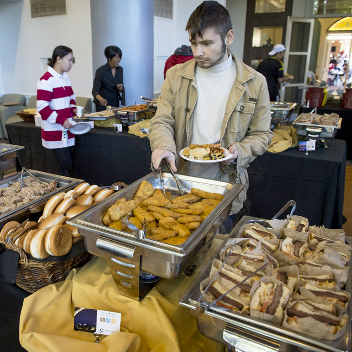 Man at buffet line with many choices.