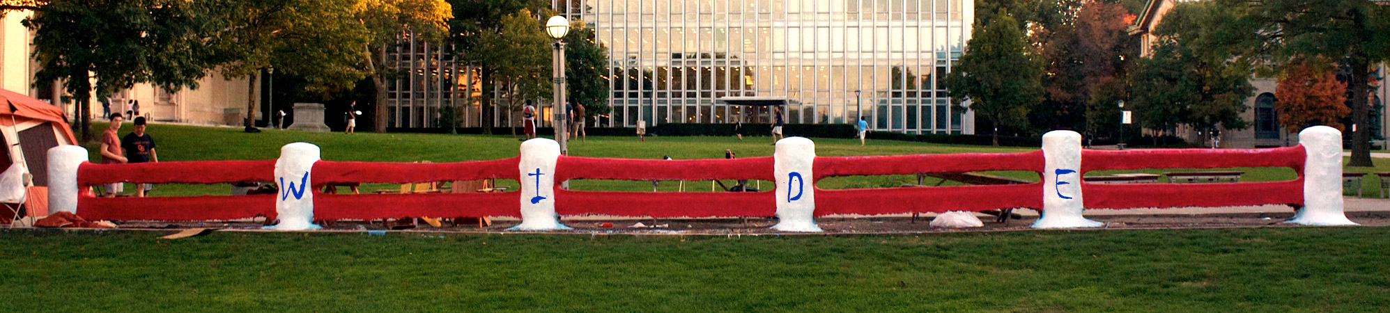 full width photo of the Fence on campus with the word wide painted on it