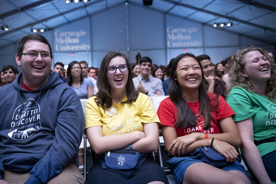 A group of students laughing at orientation.