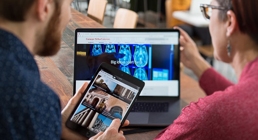 photo of man and woman looking at CMU website on different devices