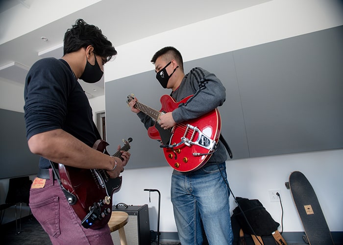 Students jam on guitars in the Commons jam room