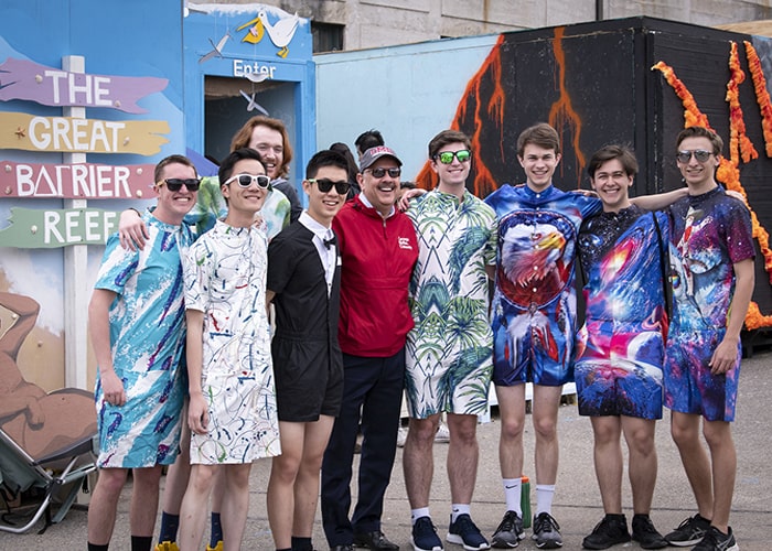 CMU students pose with President Jahanian in front of Carnival Booths