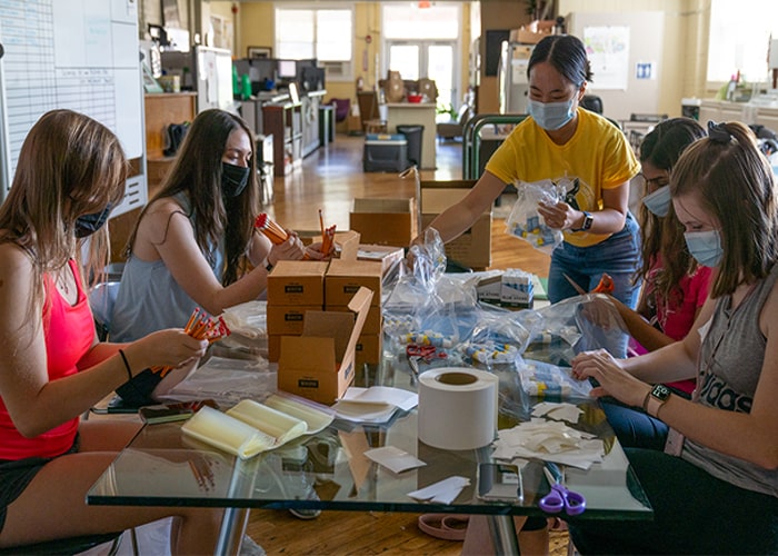 Students pack pencils together as part of CMU's Day of Service